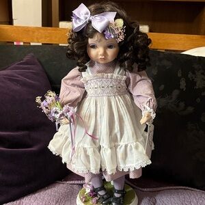 Shy Violet, by heritage Elegant Purple and White Doll with Bow.